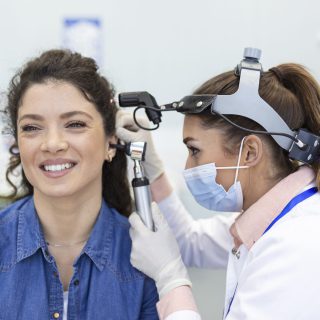 hearing-exam-otolaryngologist-doctor-checking-woman-s-ear-using-otoscope-auriscope-medical-clinic